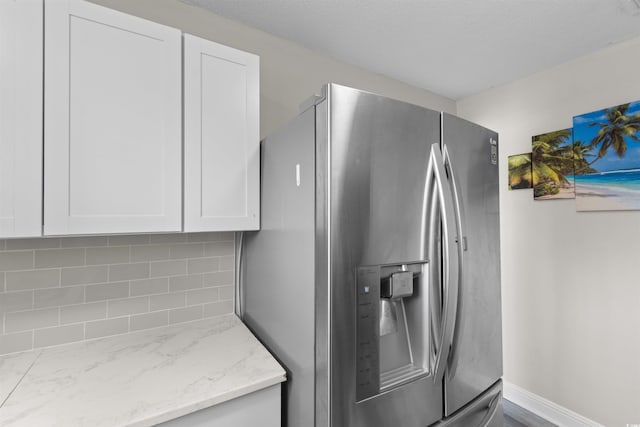 2000 Greens Blvd Unit 40C, Myrtle Beach, SC 29577 - kitchen featuring stainless steel refrigerator with ice dispenser, white cabinets, decorative backsplash, and light stone countertops