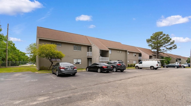 2000 Greens Blvd Unit 40C, Myrtle Beach, SC 29577 - view of building exterior featuring uncovered parking, a residential view, and fence