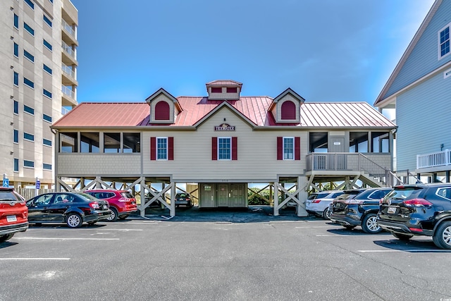 1204 Pine Valley Rd, North Myrtle Beach, SC 29582 - view of property featuring uncovered parking and stairs
