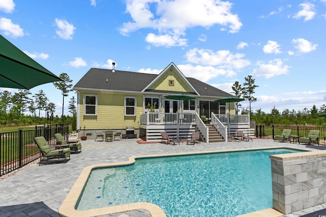 back of house with stairway, a wooden deck, a sunroom, a patio area, and fence