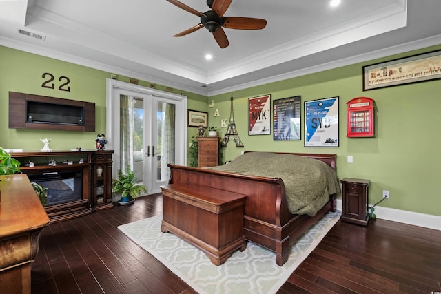 bedroom featuring a raised ceiling, wood-type flooring, french doors, access to outside, and crown molding