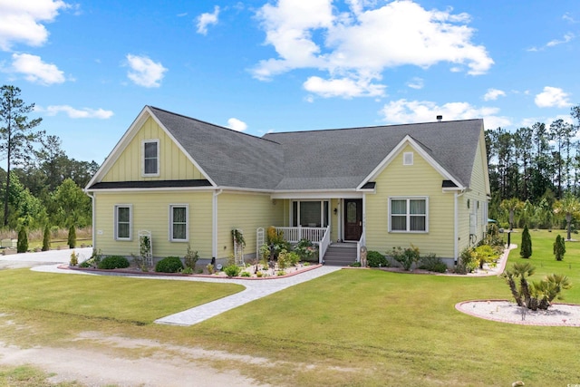 view of front of property with board and batten siding, a porch, a front lawn, and a shingled roof