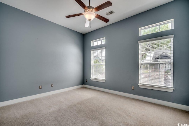unfurnished room featuring a ceiling fan, baseboards, and carpet flooring