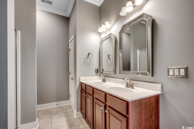 full bathroom featuring ornamental molding, double vanity, tile patterned floors, and baseboards