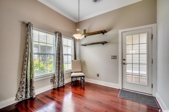 living area featuring ornamental molding, wood finished floors, and baseboards