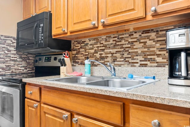 6804 N Ocean Blvd Unit 829, Myrtle Beach, SC 29572 - kitchen featuring stainless steel electric stove, black microwave, light countertops, tasteful backsplash, and a sink