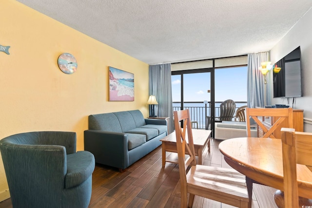 6804 N Ocean Blvd Unit 829, Myrtle Beach, SC 29572 - living room with wood finished floors, a textured ceiling, and a wall of windows