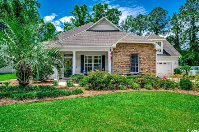 100 Woodlyn Ave, Little River, SC 29566 - view of front facade with a front yard, stone siding, a garage, and roof with shingles