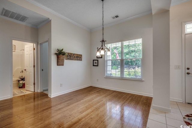 100 Woodlyn Ave, Little River, SC 29566 - unfurnished dining area featuring ornamental molding, light wood-type flooring, baseboards, and a chandelier