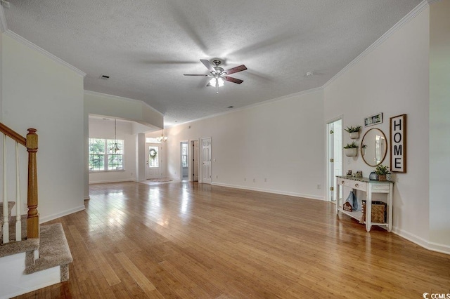 100 Woodlyn Ave, Little River, SC 29566 - unfurnished living room featuring crown molding, stairs, ceiling fan, a textured ceiling, and light wood finished floors