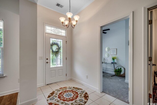 100 Woodlyn Ave, Little River, SC 29566 - foyer with a chandelier, ornamental molding, baseboards, and light tile patterned flooring