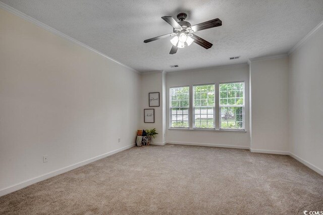 100 Woodlyn Ave, Little River, SC 29566 - spare room with a textured ceiling, carpet floors, ornamental molding, a ceiling fan, and baseboards