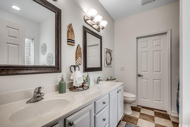 100 Woodlyn Ave, Little River, SC 29566 - bathroom featuring double vanity, toilet, and tile patterned floors