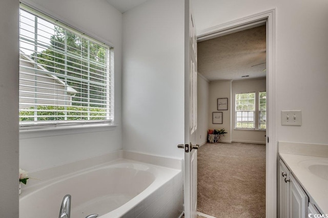 100 Woodlyn Ave, Little River, SC 29566 - full bathroom with a garden tub, vanity, and a textured ceiling