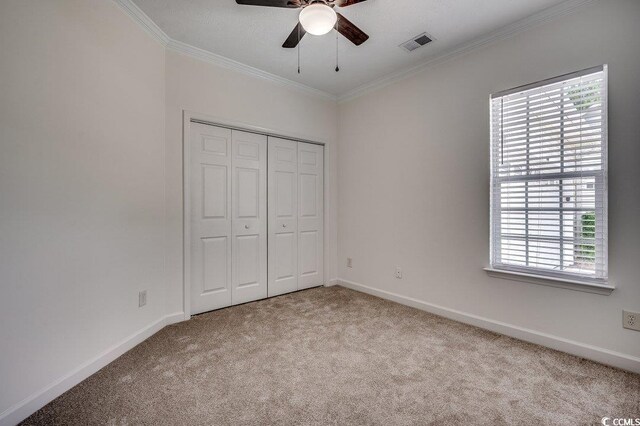 100 Woodlyn Ave, Little River, SC 29566 - unfurnished bedroom featuring carpet floors, ornamental molding, multiple windows, and baseboards