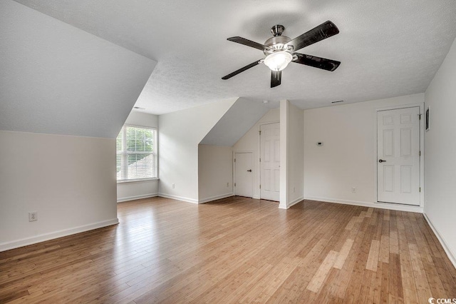 100 Woodlyn Ave, Little River, SC 29566 - additional living space featuring ceiling fan, a textured ceiling, light wood-style flooring, baseboards, and lofted ceiling