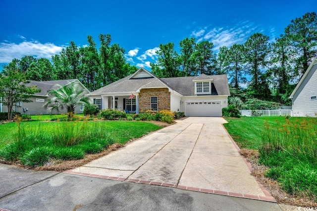 100 Woodlyn Ave, Little River, SC 29566 - view of front of property featuring stone siding, concrete driveway, and a garage
