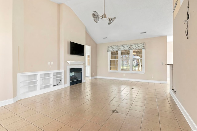 8204 Caddis Ct, Myrtle Beach, SC 29579 - unfurnished living room with tile patterned flooring, vaulted ceiling, and a glass covered fireplace