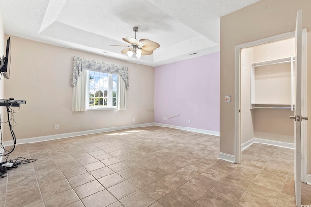 8204 Caddis Ct, Myrtle Beach, SC 29579 - unfurnished room with a raised ceiling, a ceiling fan, and a textured ceiling