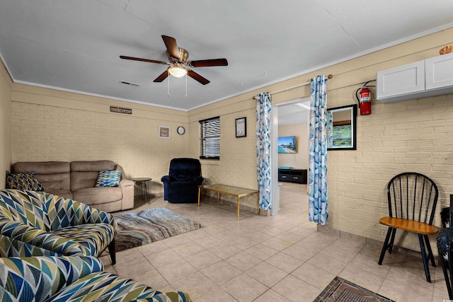 1111 King St, Myrtle Beach, SC 29577 - living room with light tile patterned flooring, a ceiling fan, brick wall, and ornamental molding