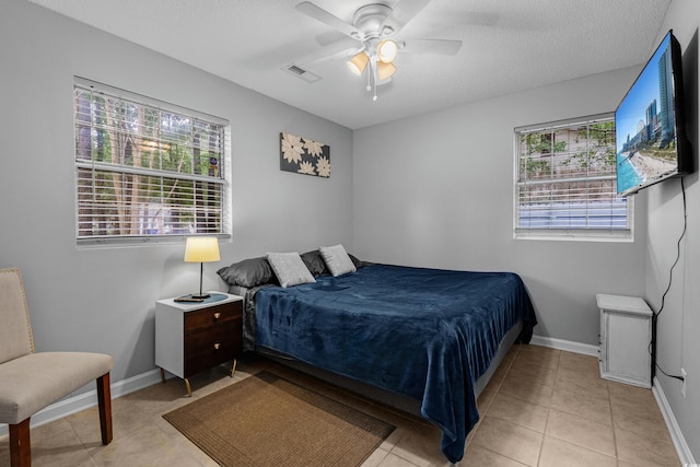 1111 King St, Myrtle Beach, SC 29577 - bedroom with multiple windows, light tile patterned floors, and a ceiling fan