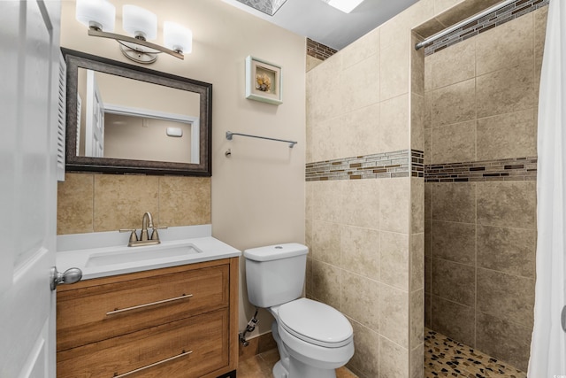 1111 King St, Myrtle Beach, SC 29577 - bathroom featuring walk in shower, vanity, and tile walls