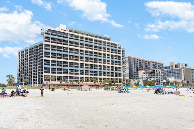 view of building exterior with view of water and beach
