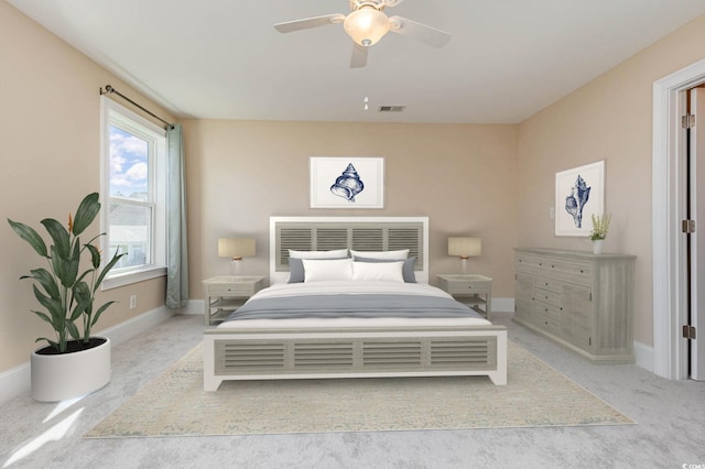 carpeted bedroom featuring baseboards and a ceiling fan