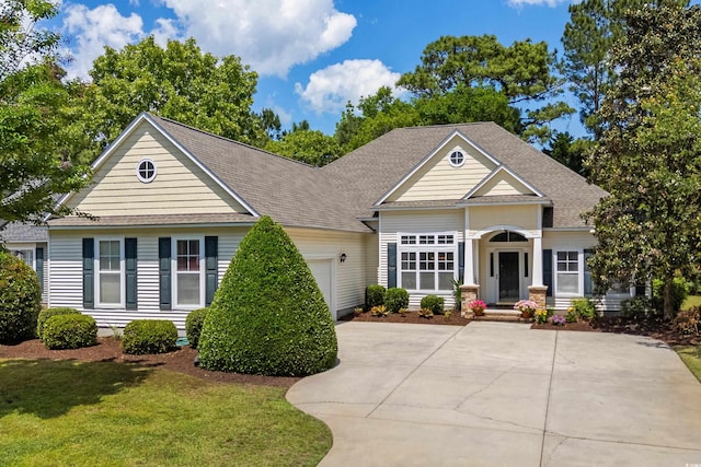 190 Barony Pl, Pawleys Island, SC 29585 - view of front of property with a garage, concrete driveway, a front yard, and a shingled roof