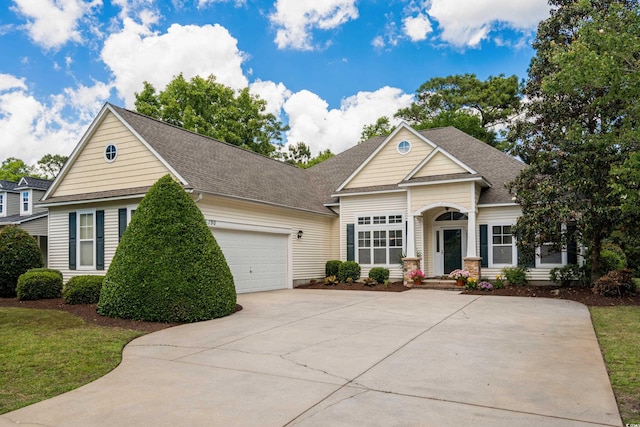 190 Barony Pl, Pawleys Island, SC 29585 - view of front of home with driveway, an attached garage, a shingled roof, and a front lawn