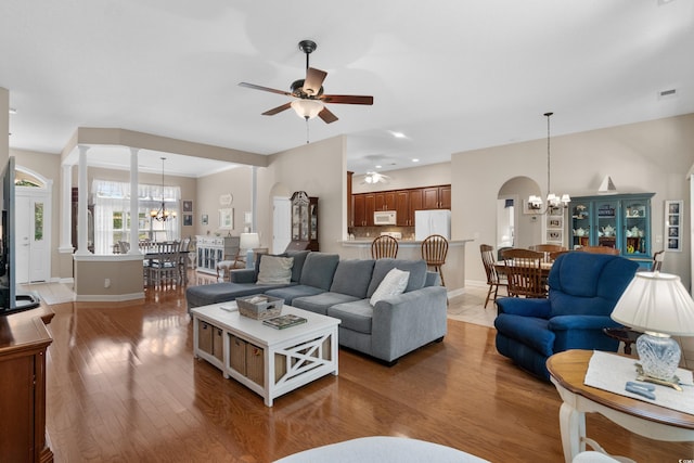 190 Barony Pl, Pawleys Island, SC 29585 - living room with a chandelier, ceiling fan, light wood-style floors, arched walkways, and recessed lighting
