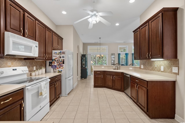 190 Barony Pl, Pawleys Island, SC 29585 - kitchen featuring white appliances, a peninsula, a ceiling fan, light countertops, and backsplash