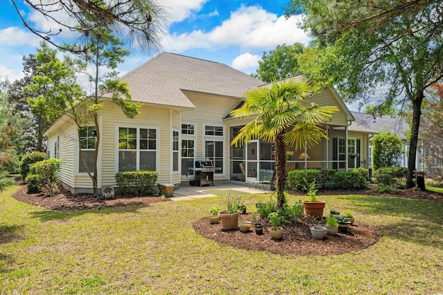 190 Barony Pl, Pawleys Island, SC 29585 - back of house with a sunroom, a lawn, a patio area, and a shingled roof