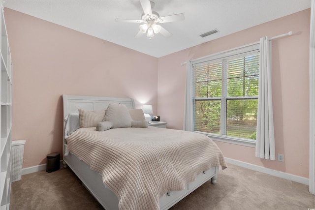 190 Barony Pl, Pawleys Island, SC 29585 - carpeted bedroom featuring baseboards, multiple windows, and ceiling fan