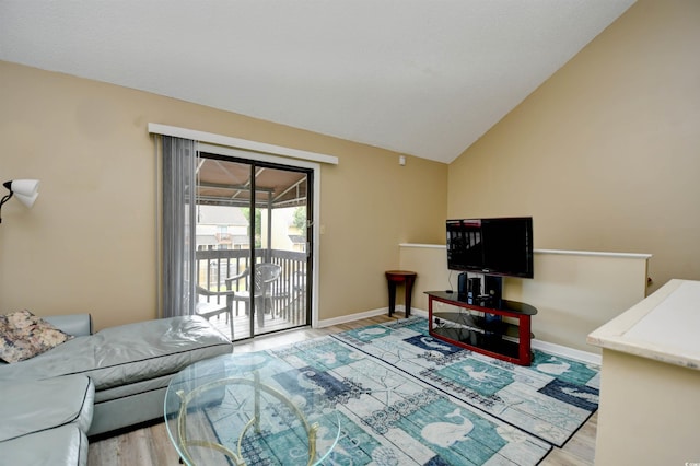 living room featuring light wood-style flooring, lofted ceiling, and baseboards