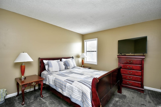 bedroom with carpet flooring, baseboards, and a textured ceiling