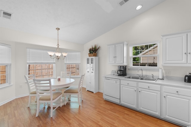 kitchen featuring dishwasher, a sink, vaulted ceiling, a chandelier, and light wood-style flooring