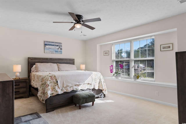 carpeted bedroom featuring a ceiling fan and baseboards