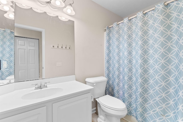 bathroom with toilet, vanity, and a shower with curtain