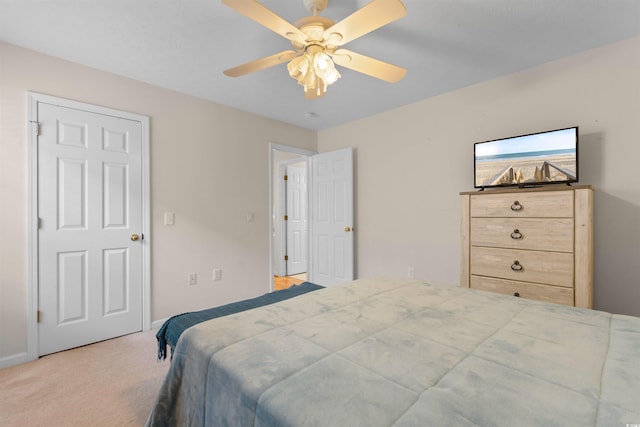 carpeted bedroom with a ceiling fan and baseboards