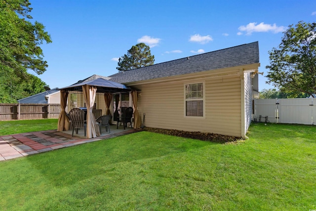 back of house featuring a gazebo, a patio, and a shingled roof
