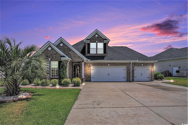 967 Henry James Dr, Myrtle Beach, SC 29579 - view of front facade with brick siding, an attached garage, driveway, a yard, and a shingled roof