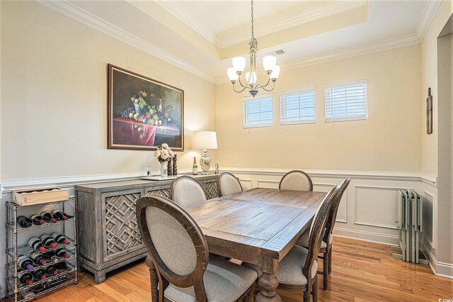 967 Henry James Dr, Myrtle Beach, SC 29579 - dining room with a chandelier, a tray ceiling, light wood-style flooring, radiator, and ornamental molding