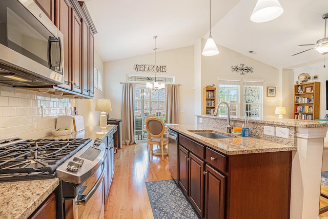 967 Henry James Dr, Myrtle Beach, SC 29579 - kitchen with appliances with stainless steel finishes, a sink, light wood-style floors, backsplash, and a chandelier