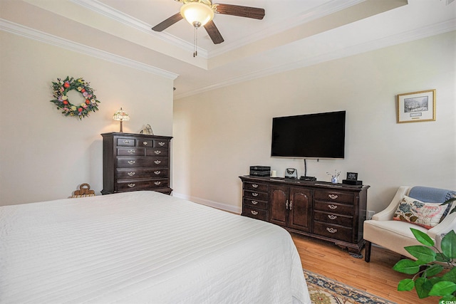 967 Henry James Dr, Myrtle Beach, SC 29579 - bedroom featuring light wood-type flooring, a tray ceiling, ornamental molding, and ceiling fan