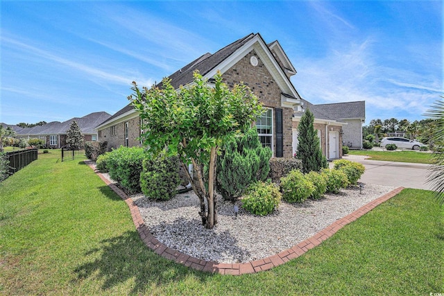 967 Henry James Dr, Myrtle Beach, SC 29579 - view of side of home with brick siding, an attached garage, and concrete driveway
