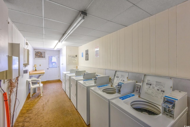 shared laundry with separate washer and dryer and light colored carpet