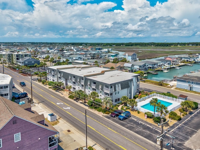 aerial view of a pool area and a large body of water