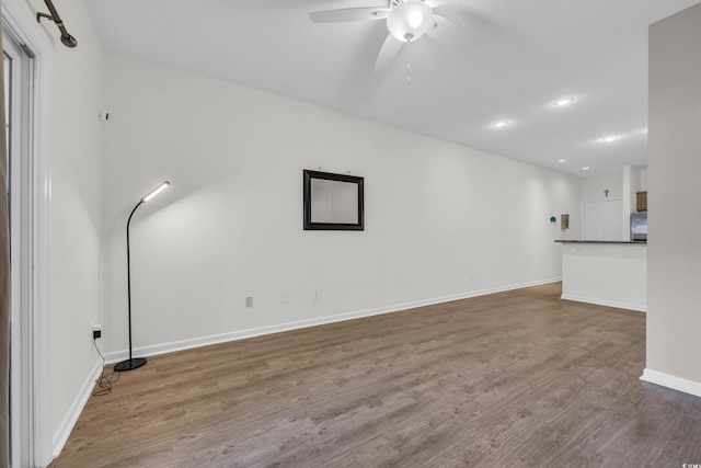unfurnished living room featuring ceiling fan, wood finished floors, baseboards, and recessed lighting