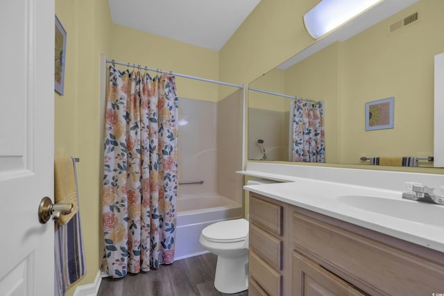 bathroom featuring wood finished floors, vanity, shower / bath combo with shower curtain, and toilet